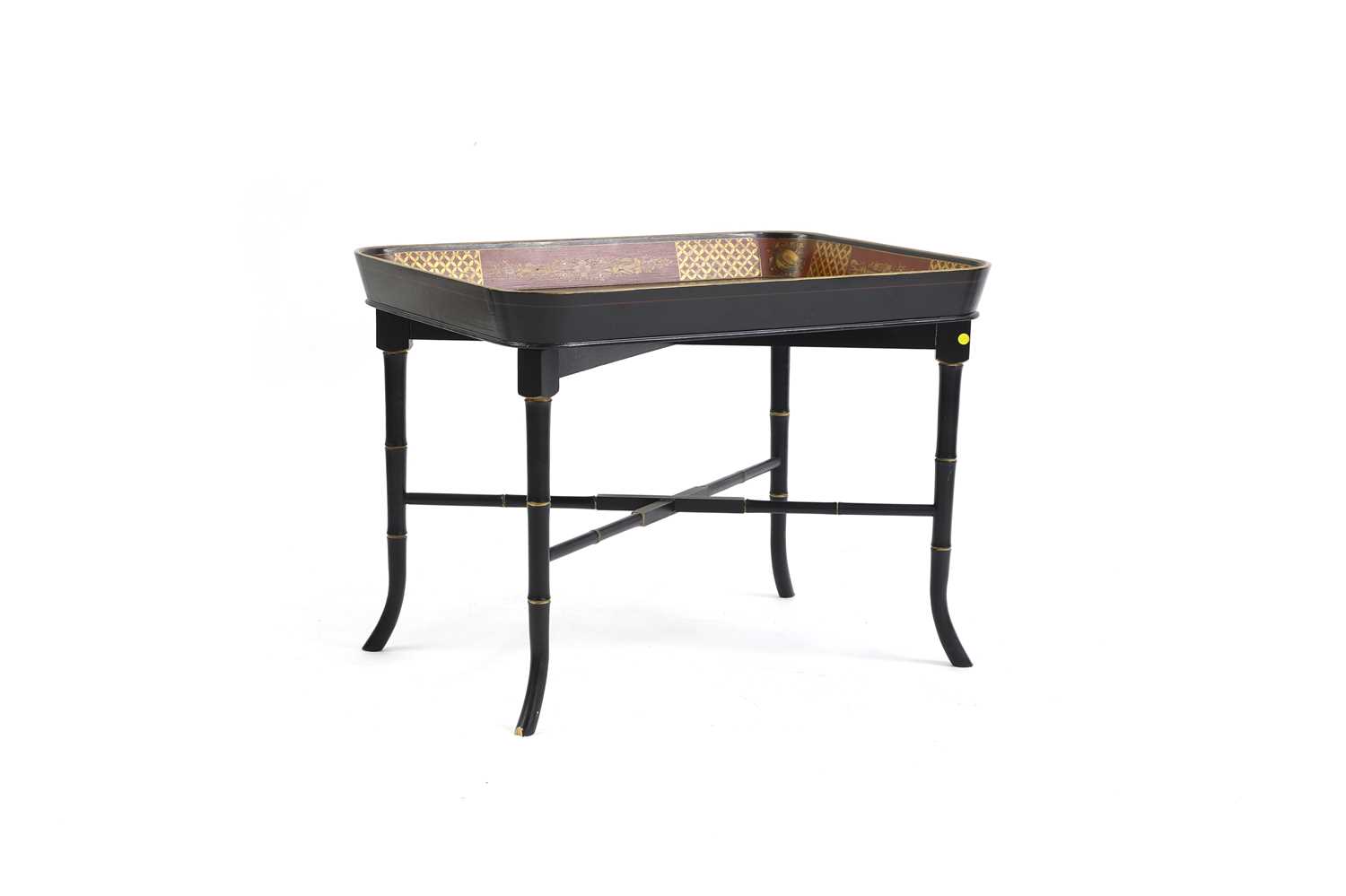 A Regency-style ebonised and parcel-gilt tray table,