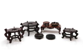 A collection of eight Chinese wood stands,