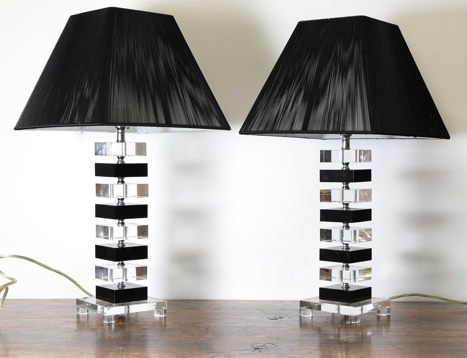 A pair of clear and black glass table lamps,