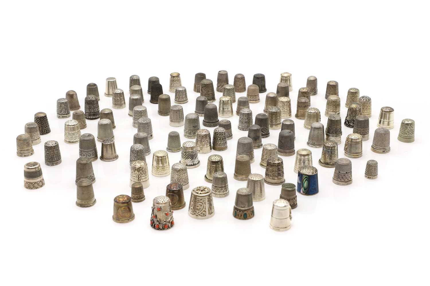 A large collection of silver thimbles