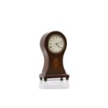 An Edwardian mahogany balloon clock,