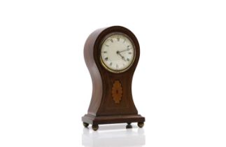 An Edwardian mahogany balloon clock,