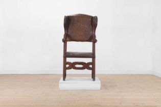 An oak and leather wingback open armchair,