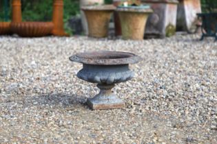 A small cast iron garden urn