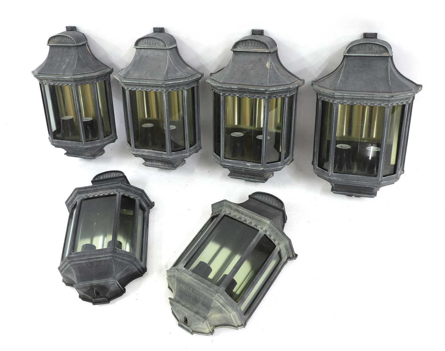 A set of six metal wall lanterns,