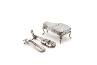 A group of silver novelty musical instruments