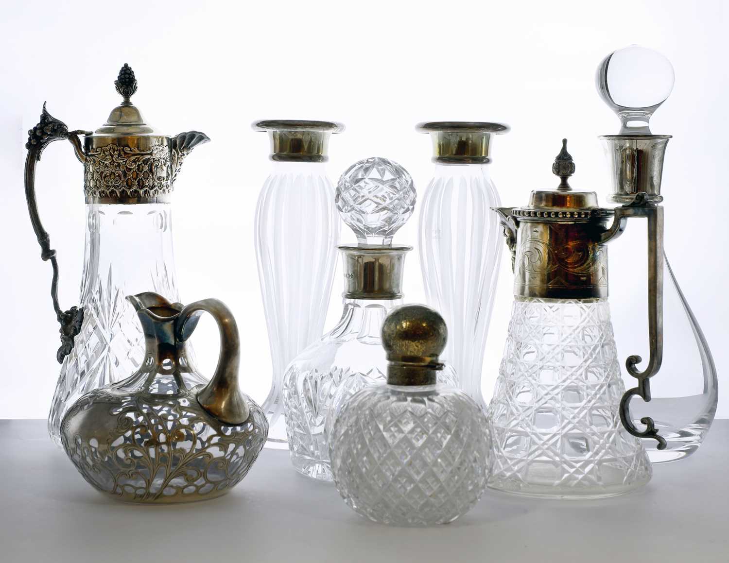 A collection of silver mounted decanters