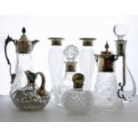 A collection of silver mounted decanters