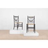 A pair of ebonised wooden side chairs,