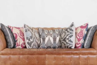 Seven patterned fabric cushions,