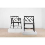 A pair of ebonised bamboo ‘cockpen’ elbow chairs,