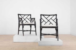 A pair of ebonised bamboo ‘cockpen’ elbow chairs,