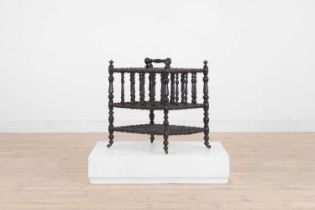 An ebonised wooden magazine rack,