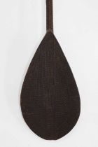 A carved hardwood paddle,