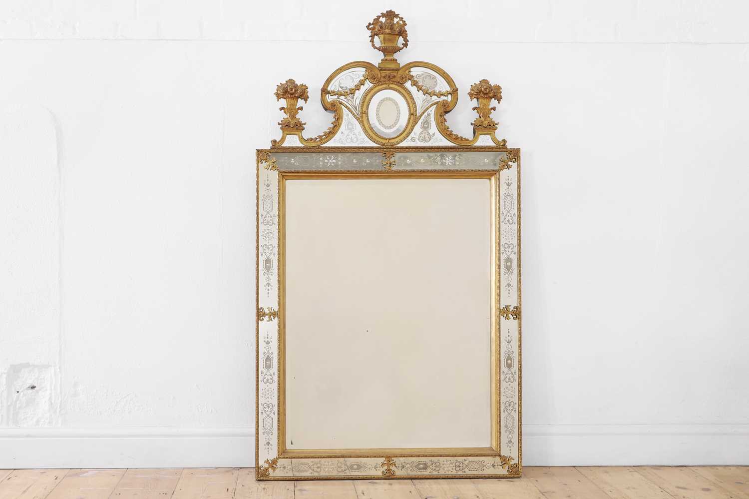 A gilt-metal, giltwood and etched glass wall mirror, after the model by Burchard Precht,