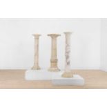 A group of three alabaster pedestals,