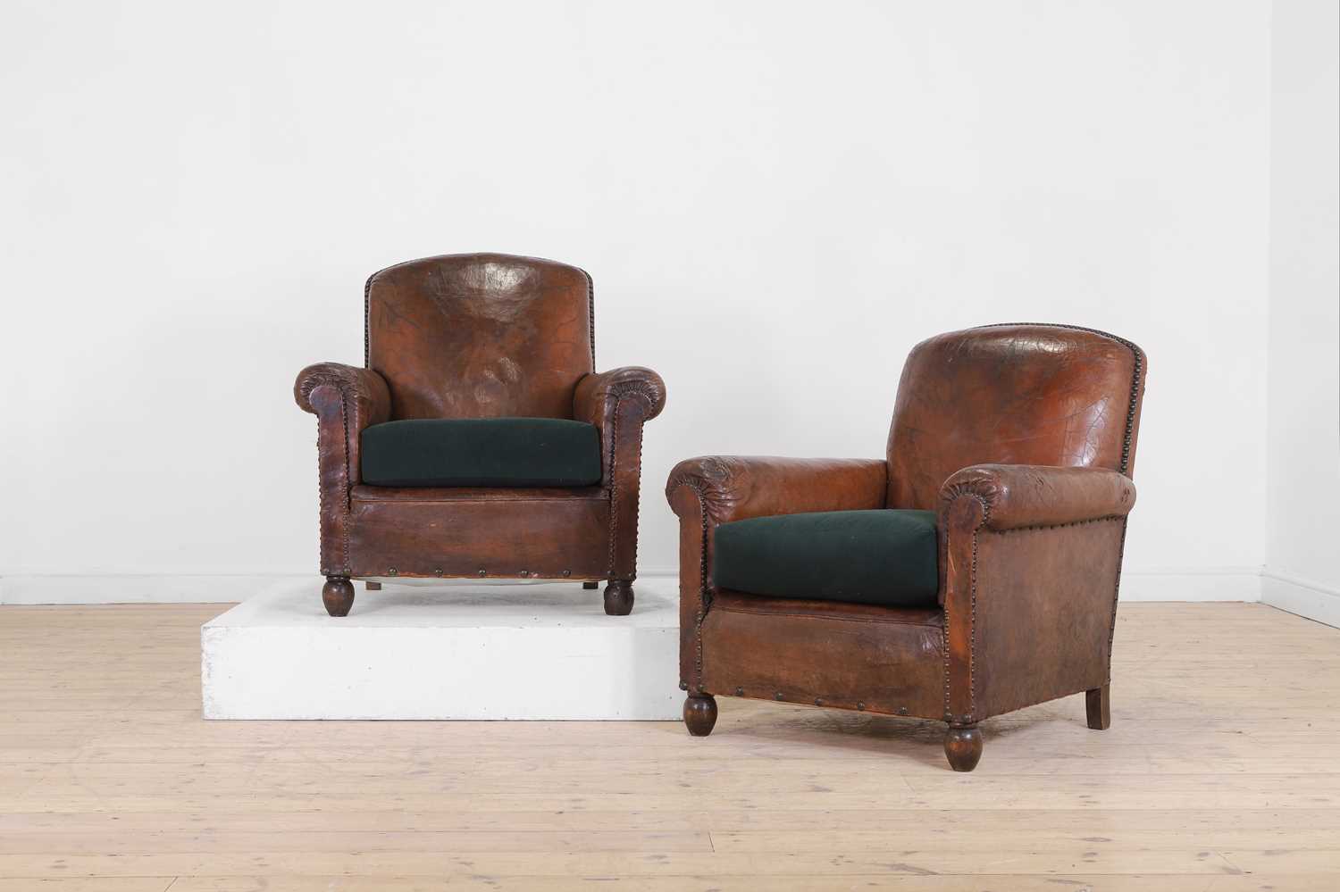 A pair of leather club armchairs,