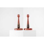 A pair of export red lacquer candlesticks,