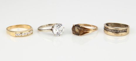 Four 9ct gold stone-set rings - comprising a yellow gold and diamond half eternity ring, unmarked,