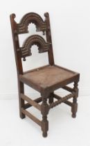 A 17th century Yorkshire oak back stool - the back with two arched rails with chip-carved decoration