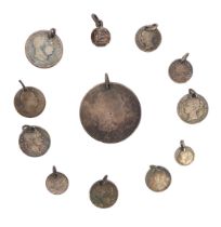 A small collection of 19th century silver coin pendants or charms - all drilled and with a loop