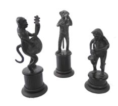 An Indian patinated brass three-piece monkey band - the dark patinated brass figures each standing