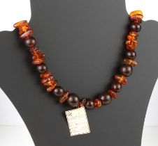 A Baltic amber bead necklace - with clear polished, irregularly shaped beads and darker spherical