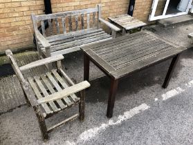 A teak garden bench - with slatted back, 129cm. long; together with a similar teak garden