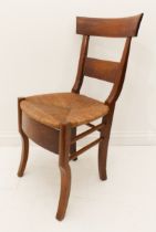A mid-19th century Continental walnut rush-seated side chair - the label back on sabre shaped