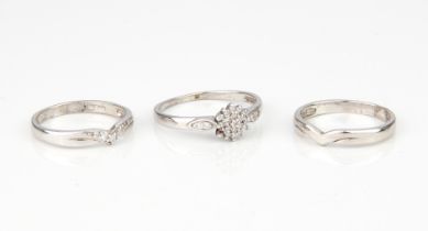 A 9ct white gold and diamond engagement, wedding and eternity ring set - comprising a diamond