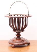 A 19th century mahogany basket jardiniere - with brass swing handle, urn shaped slatted body and