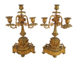 A pair of French gilt brass four-light candelabra - early 20th century, with three foliate scroll