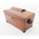 A mid-19th century mahogany sarcophagus tea caddy - with fan carved handles and turned bun feet, the