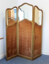 An Edwardian gilt and composition mirrored three-fold screen - the serpentine frame with lappet