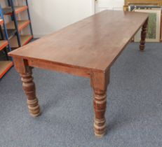A large, heavy stained pine refectory table - second half 20th century, the rectangular top raised