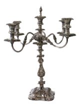 An ornate silver-plated four-branch candelabra with central sconce and snuffer (55 cm high).