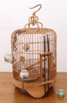 A Chinese bamboo bird cage - mid-20th century, the cylindrical cage with domed top, on bracket feet,