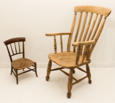 A late 19th century stripped beech and elm lathe-back chair - with slat back and swept arms over a