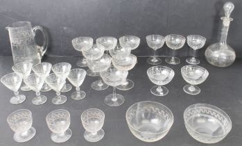 A large matched collection of Edwardian and 1920s Greek key etched drinking glasses - including a