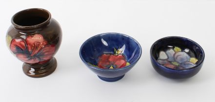 Three pieces of early 20th century Moorcroft: two small bowls (the larger, 9 cm in diameter x 4.5 cm