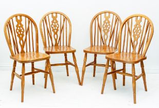 A set of four modern beech wood wheel back kitchen chairs in the 19th century style