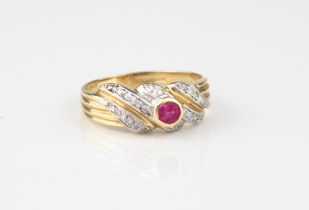A 14ct yellow gold, ruby and diamond ring - hallmarked Sheffield 2000, the central round cut ruby in