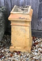 A Victorian buff terracotta chimney pot - of square tapered form with outset top and plinth base,