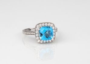 An 18ct white gold, blue topaz and diamond cluster ring - stamped '18K 750', the square cushion