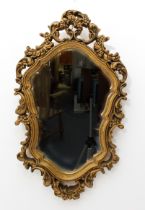 A gold painted moulded rococo style mirror - mid-20th century, cartouche form, with pierced floral