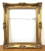 A 19th century style gilt and composition swept frame - 63.5 x 53.5cm.