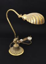 A Victorian style brass desk or reading lamp - with cast shell-shaped swivel-head shade and scroll