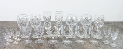 A small collection of cut glass drinking glasses with similar decoration - including a set of four