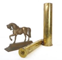 Two brass shell cases and a brass horse doorstop (3).