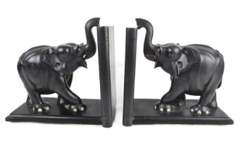 A large pair of carved ebony elephant book ends - mid-20th century, 23.5cm. high.
